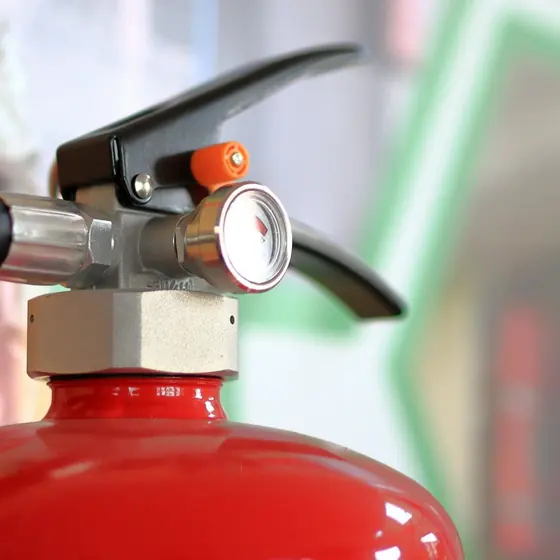 Close-up of a fire extinguisher valve and pressure gauge